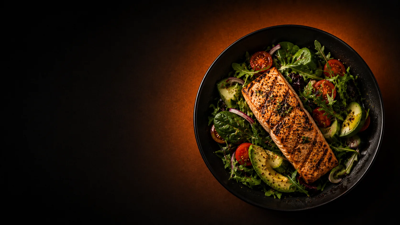 A grilled salmon salad, lit warmly
